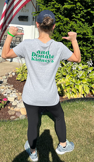 woman showing message on back of shirt